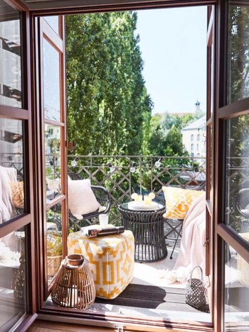 Portes ouvertes sur le balcon avec pouf jaune, meuble en bois foncé