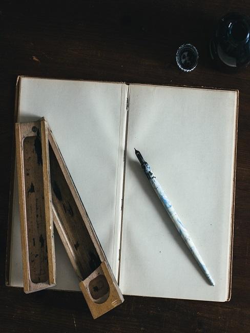 Nauka kaligrafii Zbliżenie na otwarty notes i przybory do kaligrafii