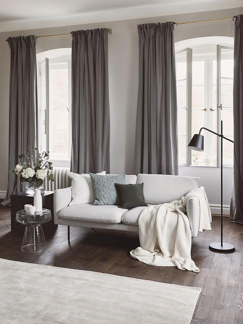 Farbkombinationen Wohnzimmer in Weiß und Grau mit grünem Kissen auf Sofa