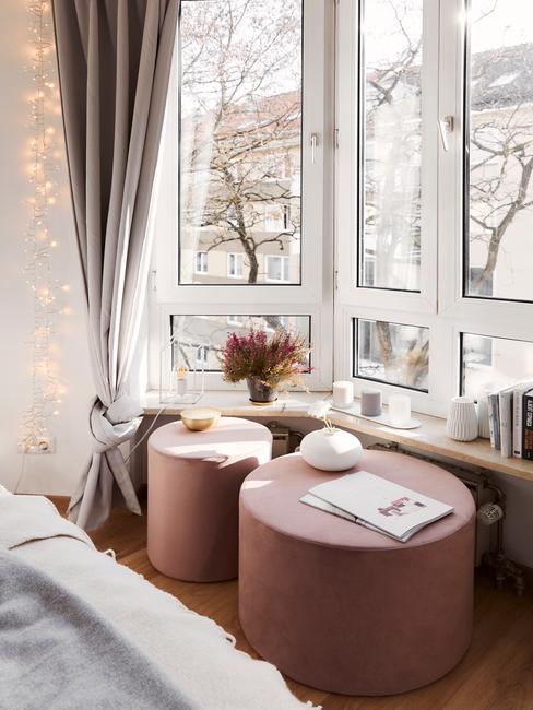 Brudny róż Pufy w kolorze pudrowego różu przy oknie wykuszowym
