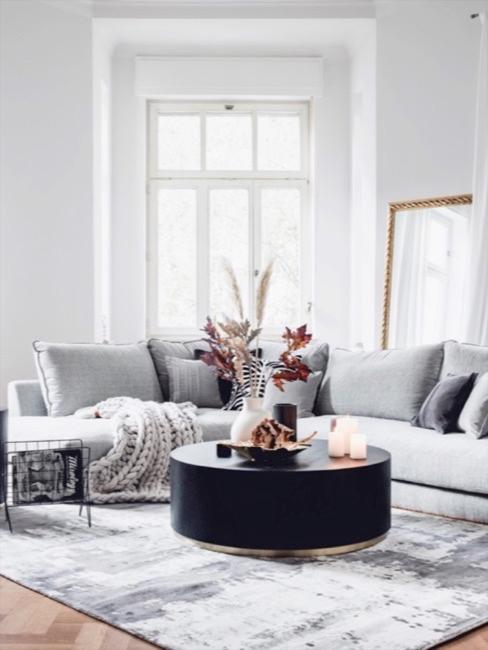 Salón con sofá gris esquinero y decoraciones con hierba de la pampa