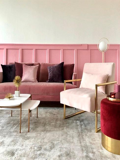 Wohnzimmer mit Altrosa Wandfarbe, Sofa, Pouf und Kissen ind Beerenfarben und Sesel in Hellrosa