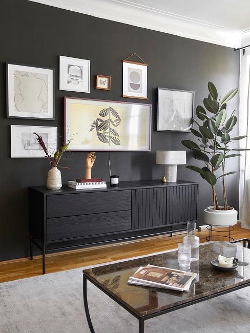 Schwarze Wand mit Bildern und schwarzem Sideboard