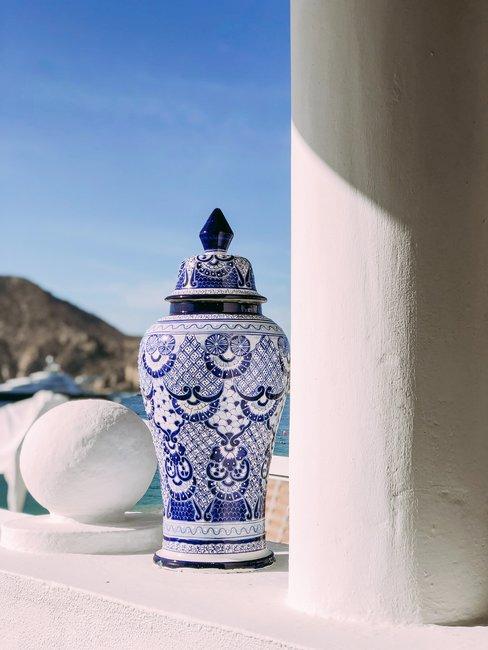 Delfts Blauw pot buiten Pot in zon op wit balkon blauwe lucht