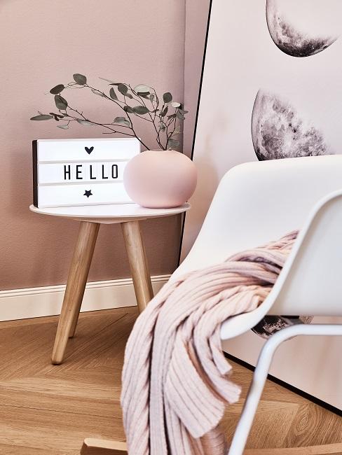 Lightbox sayings on side table next to vase