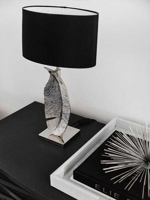 Decorative lamp with lamp base in the form of a spring on a chest of drawers