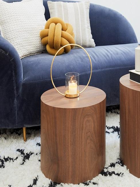 Metal ring decorative object with a candle stands on the coffee table.