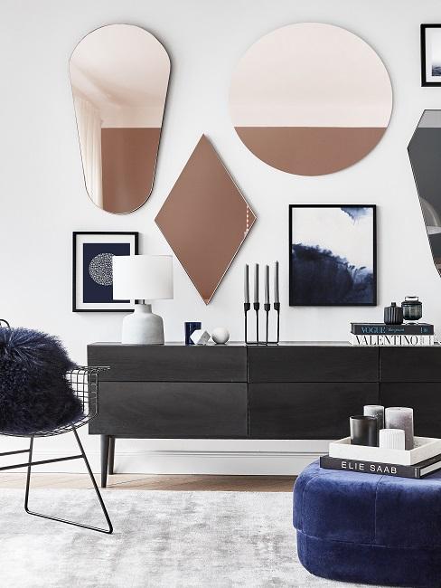 Bilder aufhängen im Rahmen über schwarzem Sideboard mit Deko