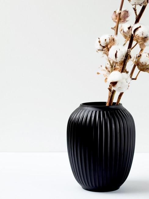Cotton branch in Kähler vase on the table
