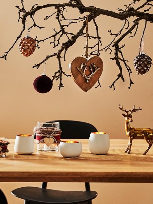 Decorate tree branch in autumn with cones, hearts and balls
