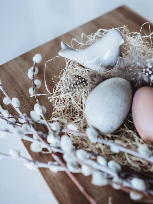 Decorate the Easter branch with Easter eggs, little birds and twigs
