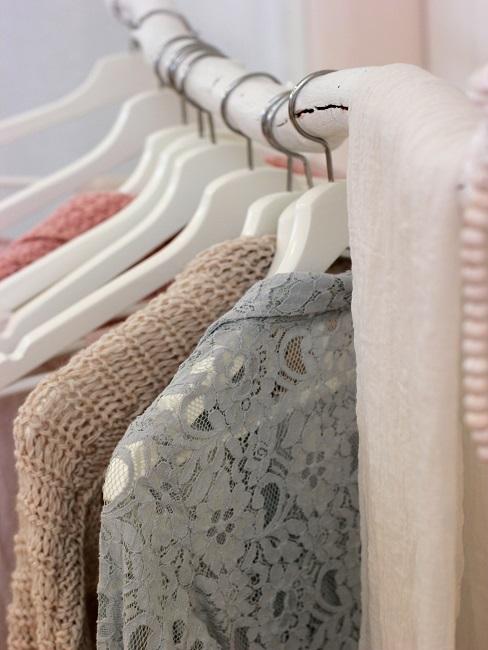 Decorate a branch as a clothes rail with hangers and clothes
