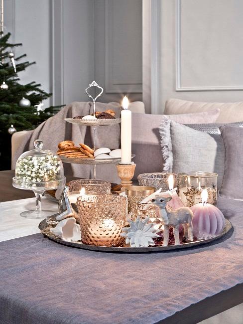 Living room with a cake stand with Christmas cookies and a tray next to it with Christmas decorations