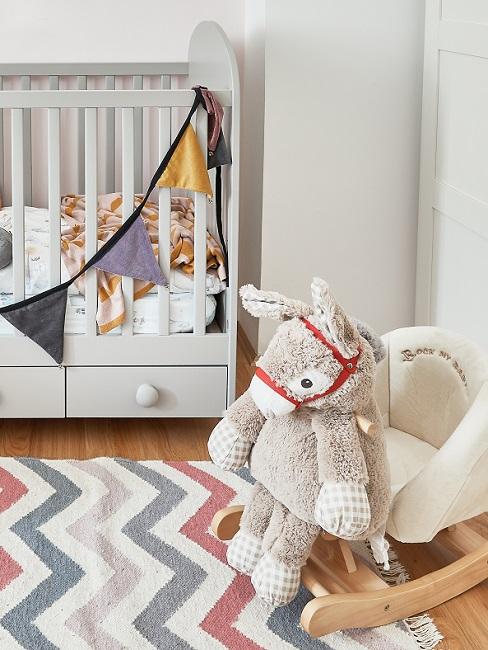 Babyzimmer komplett Banner Babyzimmer mit gestreiftem Teppich und Schaukelpferd