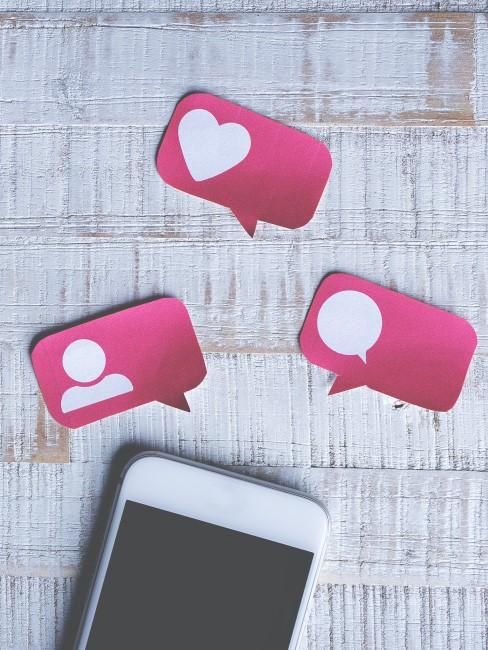 citas-online-banner Movil con emojis de comentarios, likes y personas
