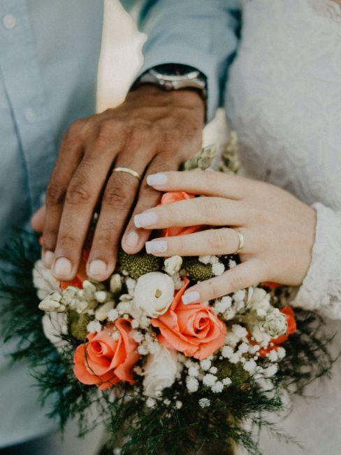 main de mariés sur un bouquet