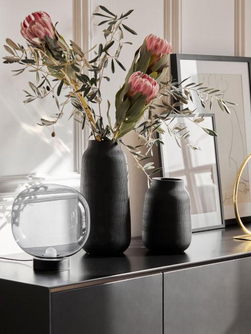 credenza nera con vasi