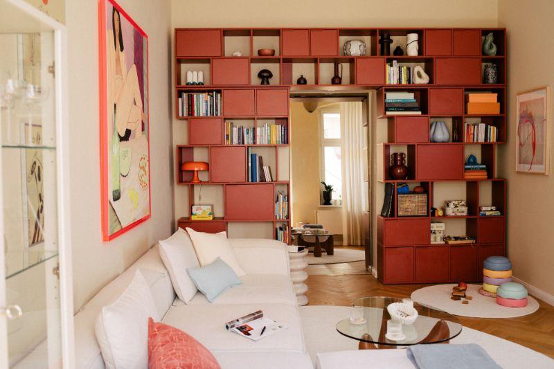 soggiorno quadrato con libreria colorata