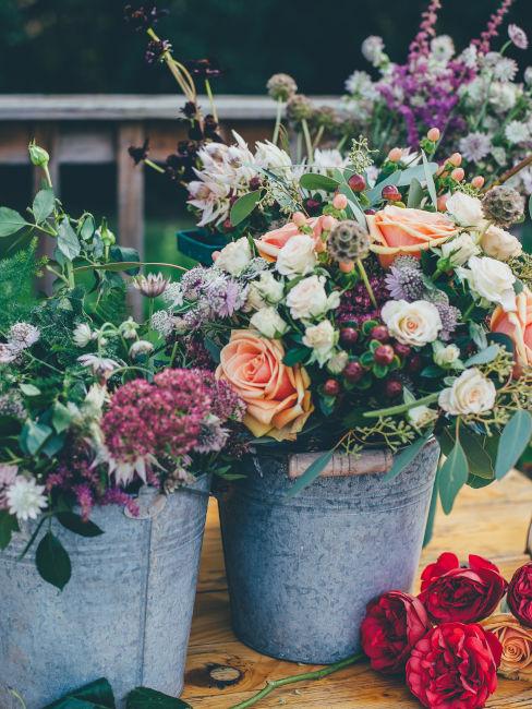 centrotavola realizzato con vasi di latta e fiori