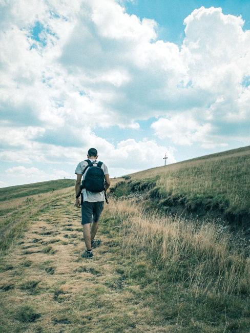 ragazzo che cammina verso una croce