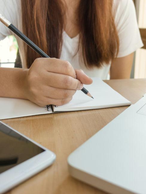 ragazza che prende appunti su blocco note