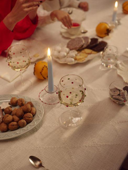 tavola di natale con arance decorative e candele azzurre