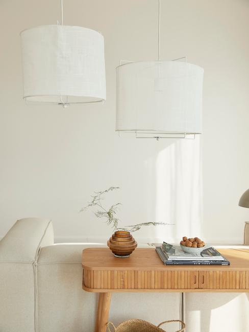witte lennon sofa met ronde linnen hanglampen en houten wandtafel