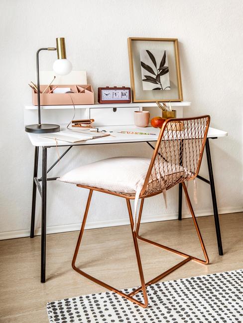 Bureau met decoratie en een stoel met een wit kussen
