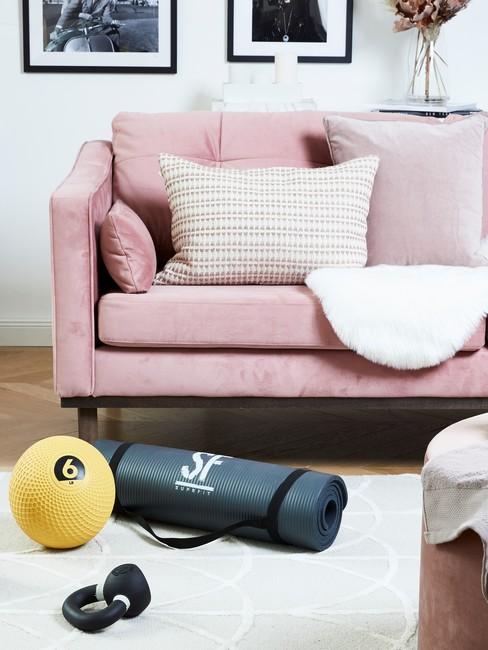 roze bank met een wit kleed en sportspullen