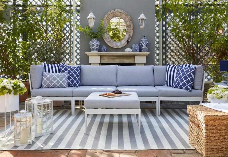 witte outdoor loungebank met blauwe kussens