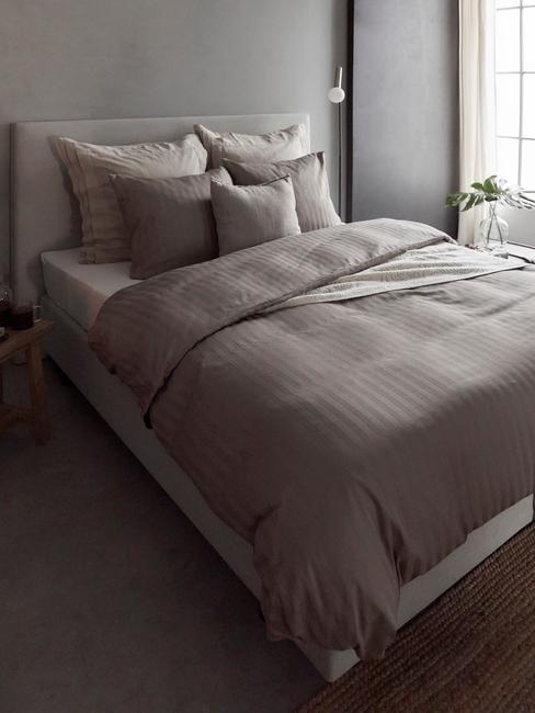 donker bed met donkere kussens