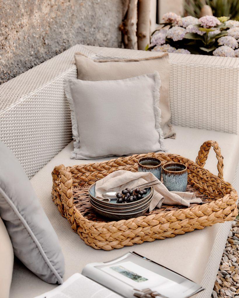 deken op een outdoor sofa met rieten dienblad