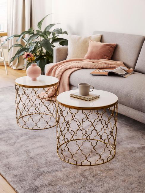 Sofa w salonie z ozdobnymi poduszkami w kolorze brzoskwiniowym