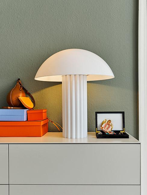 nowoczesna biała lampa na tle liwkowej ściany
