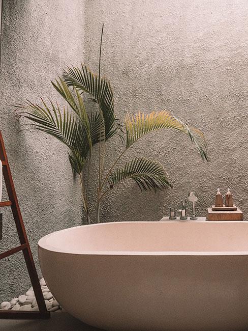 kremowa wanna na tle nietynkowanej ściany