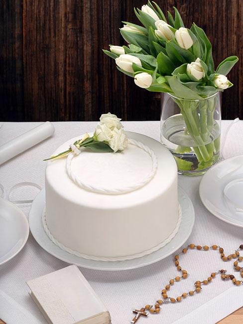 Biały tort komunijny na stole