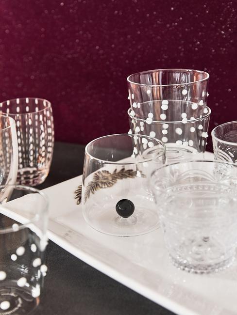 burgundowa ściana na tle szklanek na białej tacy