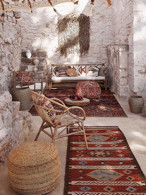 Taras w stylu marokańskiego boho z meblami z wikliny i tekstyliami w kolorze terakoty