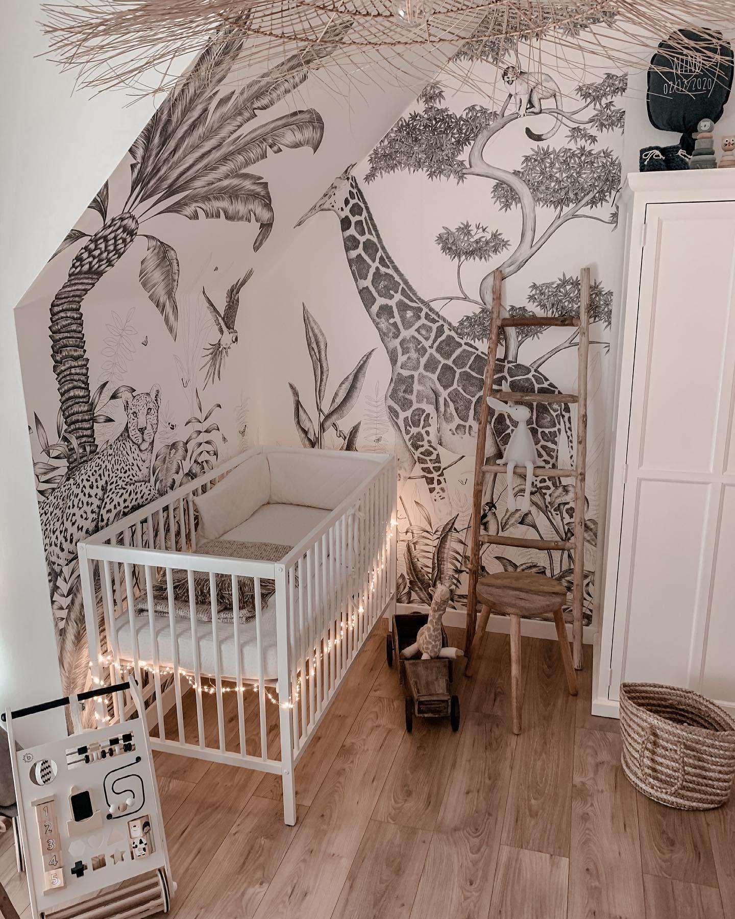 Pokój dla niemowlaka z białoczarną tapetą z motywem zwierząt afrykańskich