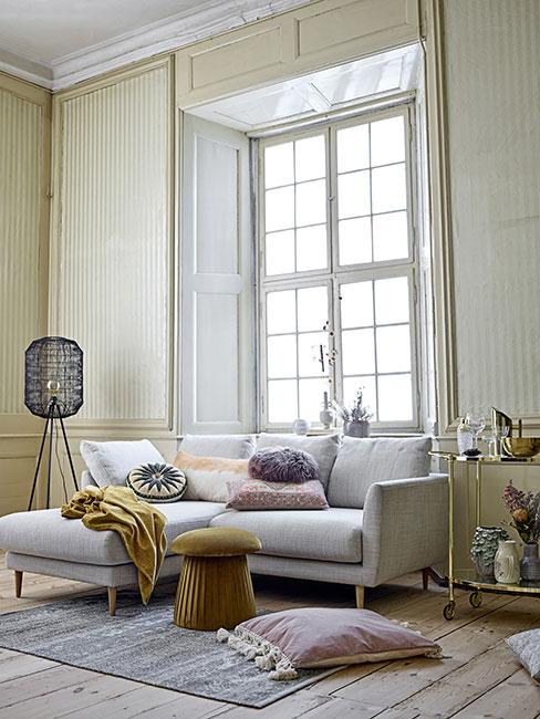 jasny salon z szarą sofą i jasnożółtymi ścianami