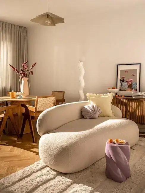 small living room with lavender dining table and beige sofa