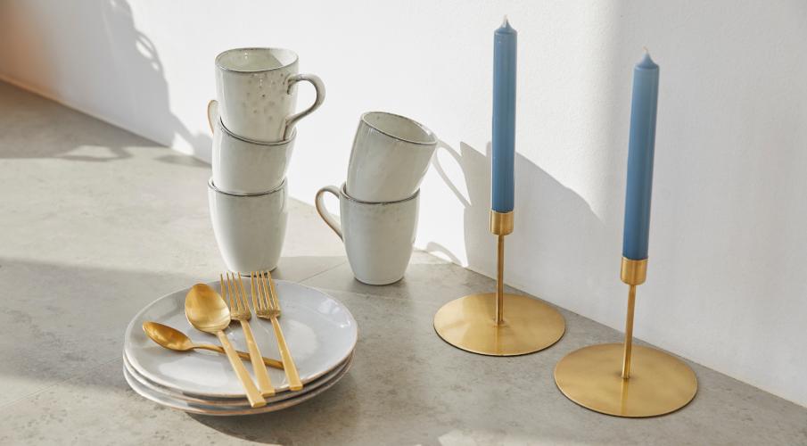 Bougies bleues, bougeoirs dorés, tasses