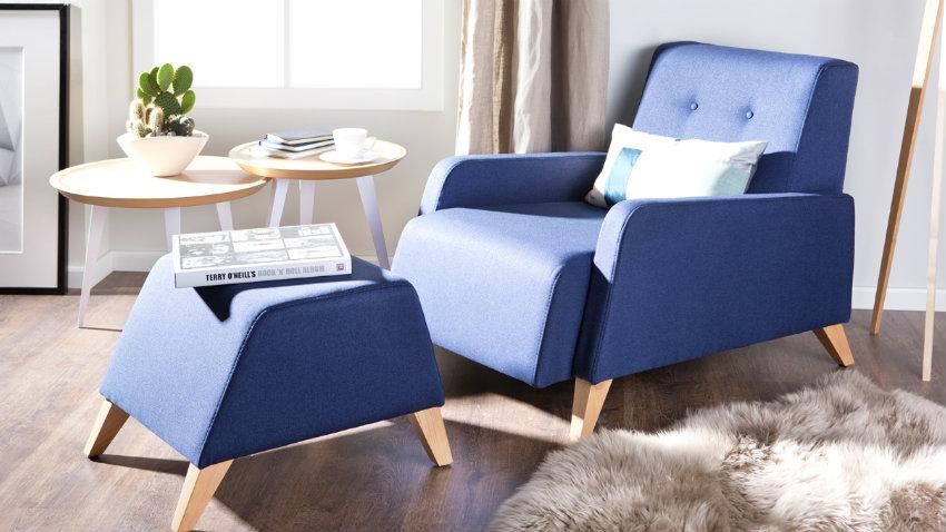 blauwe ligfauteuil met hocker en vloerkleed
