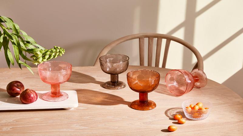 Gekleurde iitala wijnglazen op een houten tafel