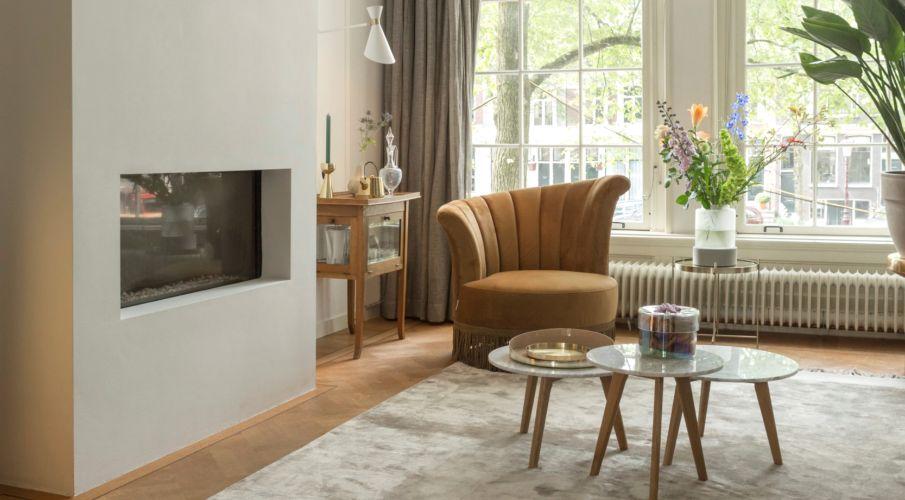 Kleine fauteuil van leer naast een openhaard