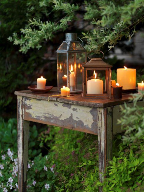 lanterne de jardin – 1 Table vintage avec différentes lanternes et bougies allumées