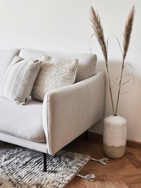 Tapizar un sofá sofá color crema en salón con decoraciones de tonos neutros