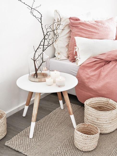 Accessoires pour une déco scandinave table de chevet scandi, paniers de rangement et linge de lit rose
