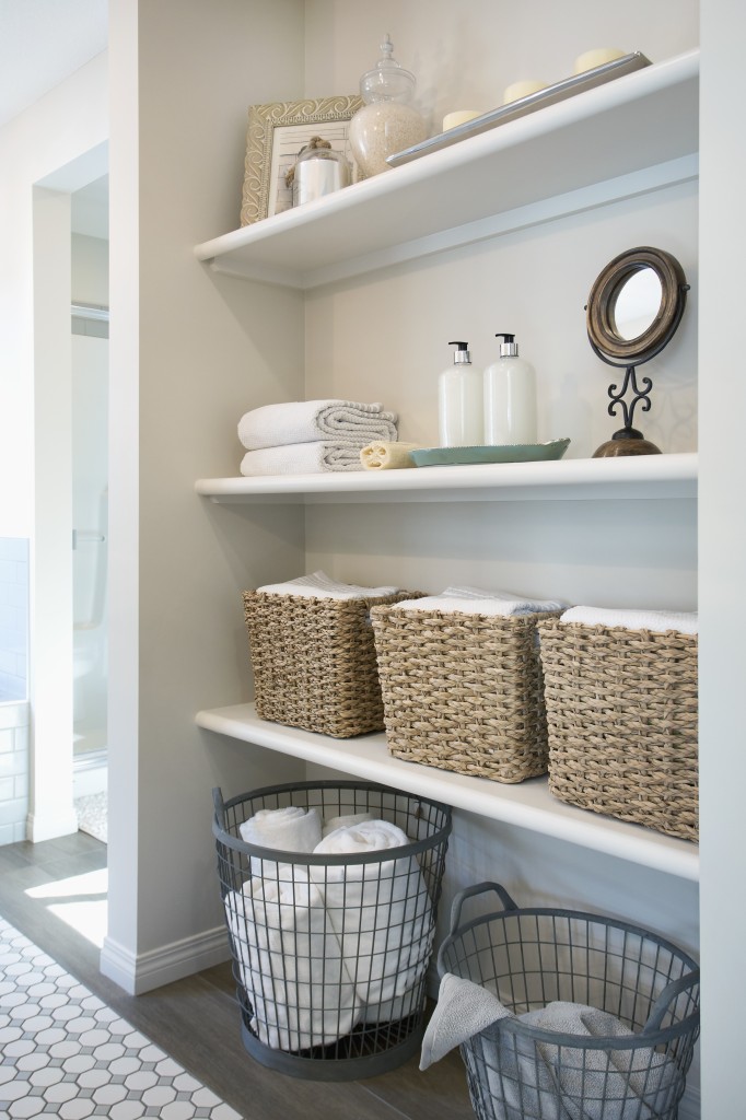 Baskets and items on bathroom shelves